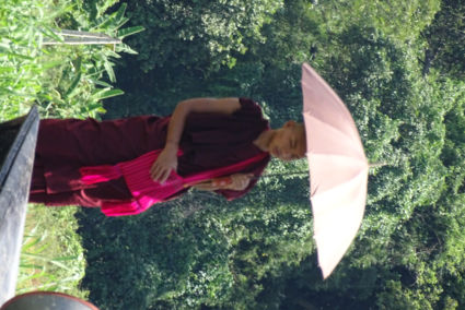 Monk in the shade of his umbrella