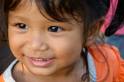 This beautiful girl was high-fiving us all the time at a market at Battambang.