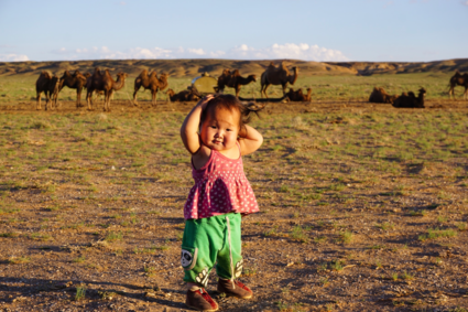 Strike a pose - Happy nomadic girl in the Gobi desert